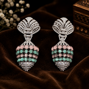 American Diamond statement drop earrings featuring a fan-shaped pavé CZ top stud, baguette CZ accents, and a textured drop of layered pink and mint green cat's eye beads from Glorious Jewels.