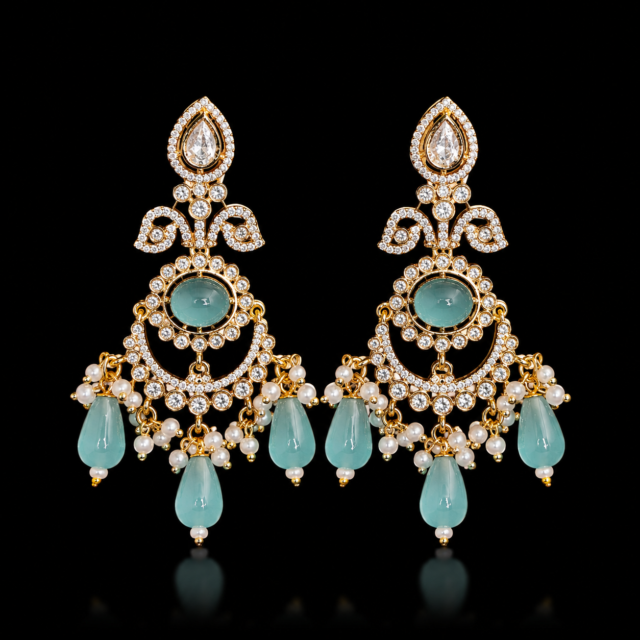 Gold-plated chandelier earrings featuring a teardrop CZ stud, intricate pavé scrollwork, a center oval sea-green stone, and hanging mint green teardrop bead drops with pearl clusters from Glorious Jewels.