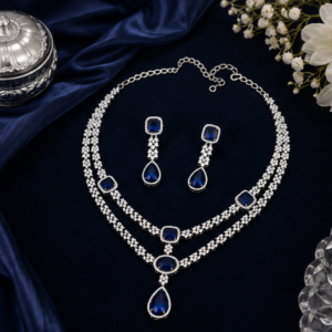 Premium silver finish layered American Diamond necklace set with royal sapphire blue stones and matching drop earrings, ideal for bridal, wedding, reception, and party wear.