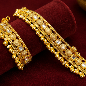 Pair of heavy gold-plated broad bridal payal anklets featuring square Kundan stones, floral motifs, pearl drops, and ghungroos.